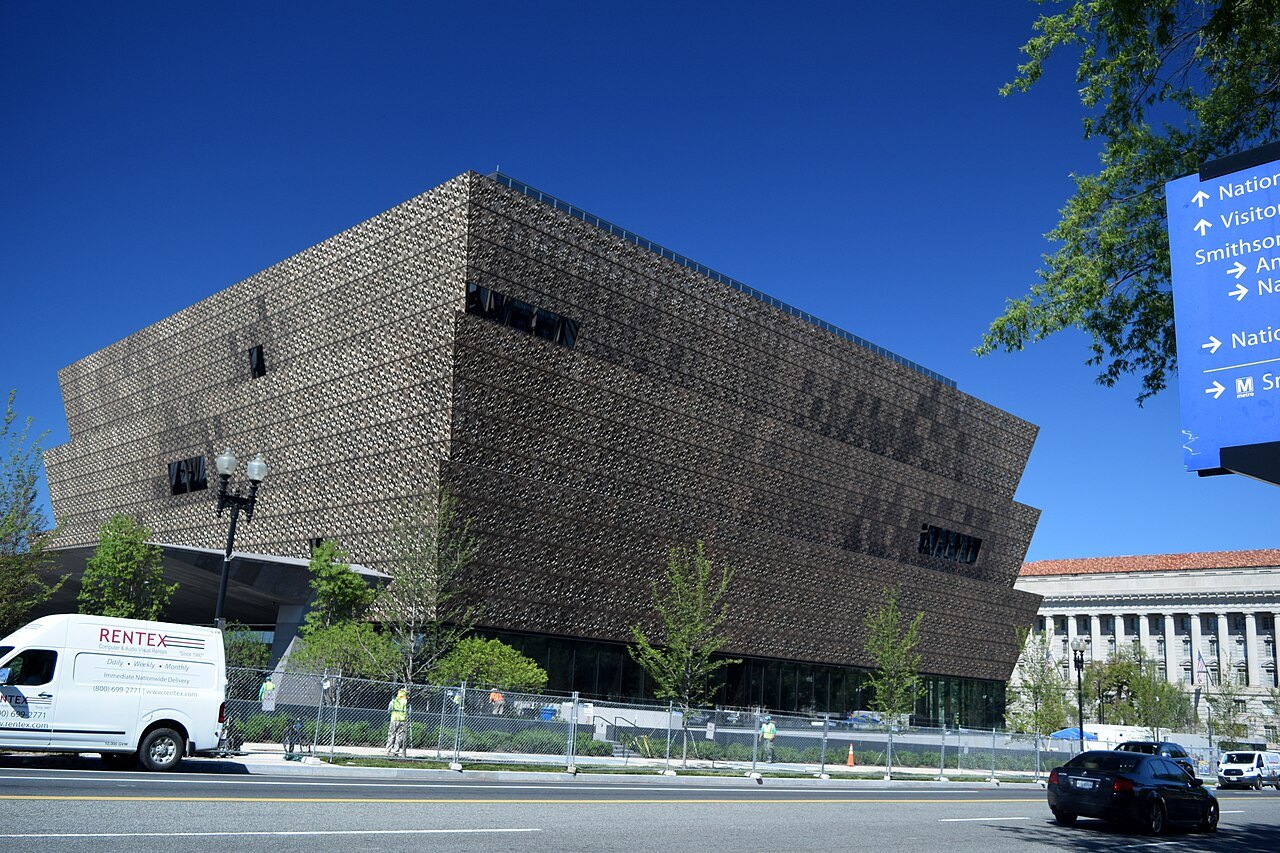 The African American History and Culture museum from Constitution Avenue, a wayfinding sign at the right