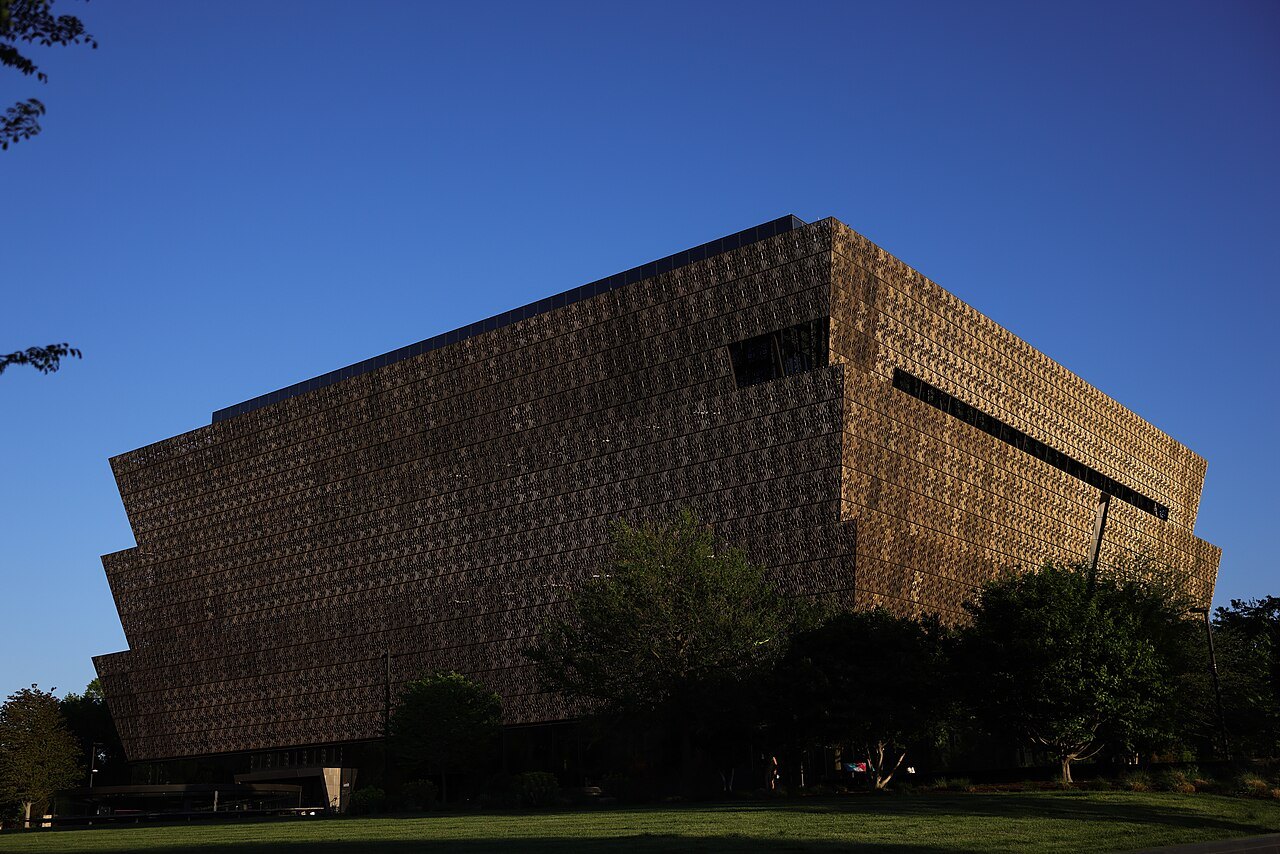 The African American History and Culture museum against a deep blue sky