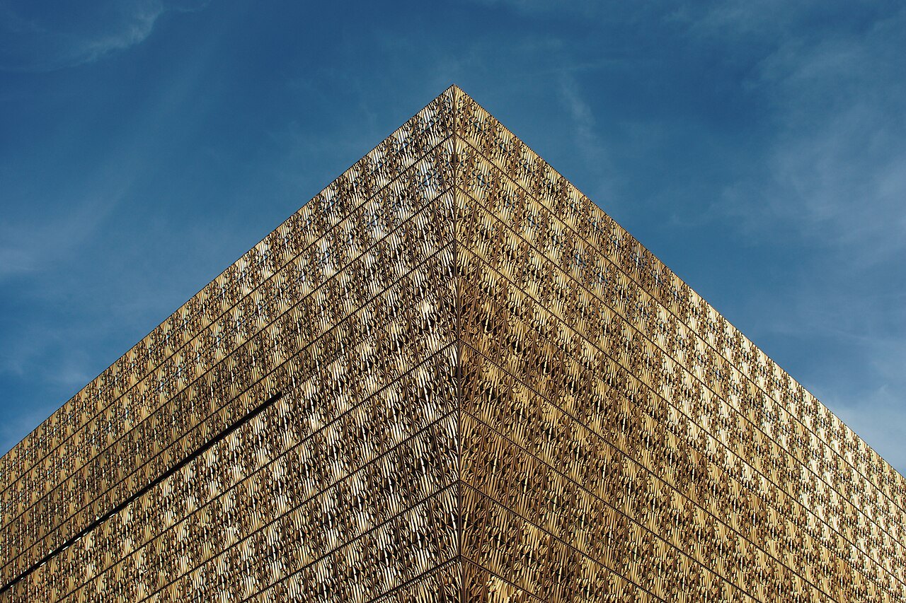 A corner of the museum's bronze corona, its lattice lit by the sun