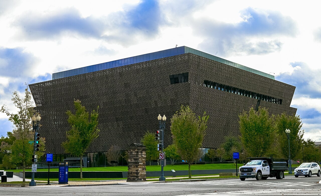 The African American History and Culture museum from the corner of the street, under cloud