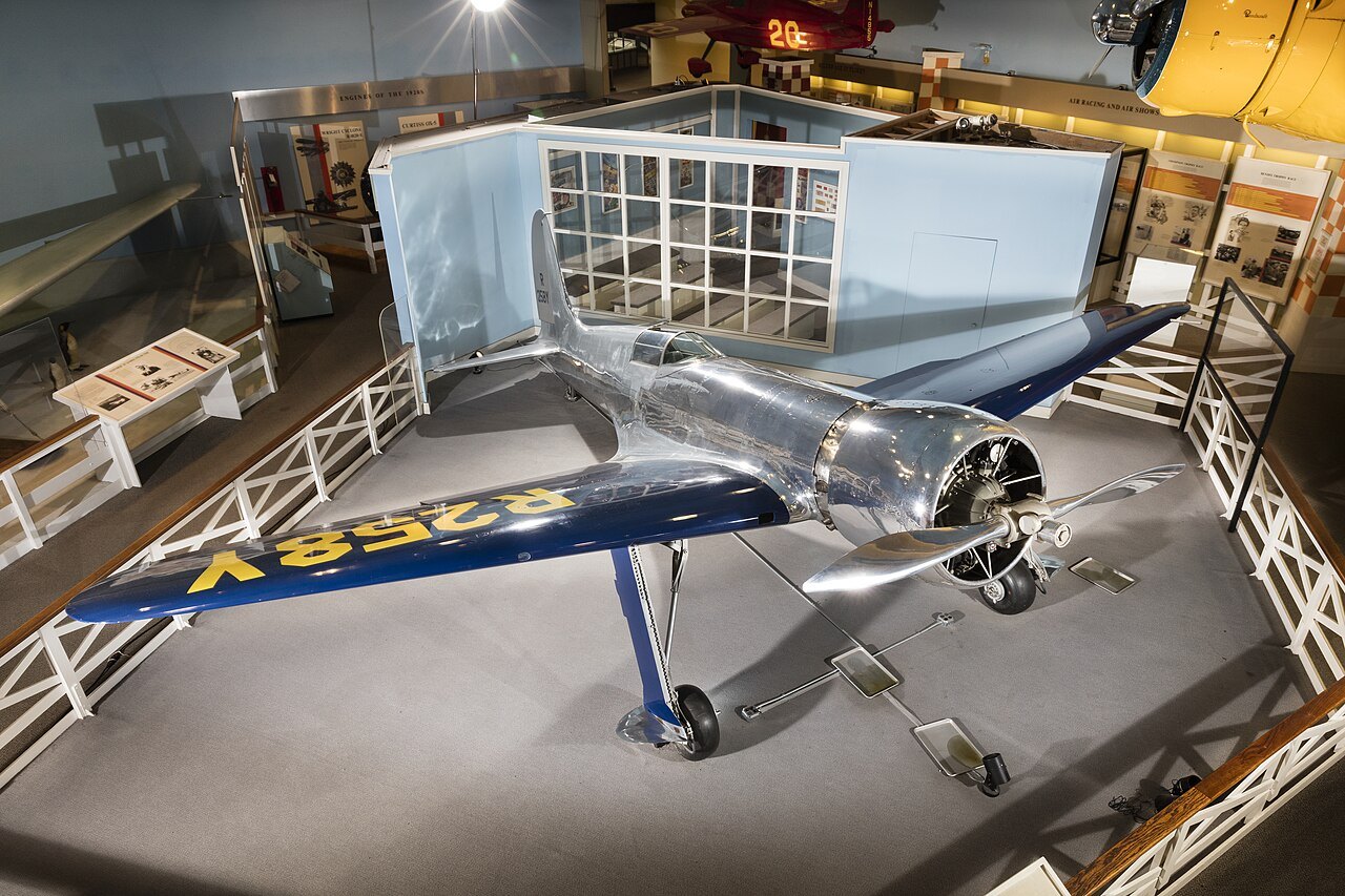 A silver racing monoplane on display inside the Air and Space Museum