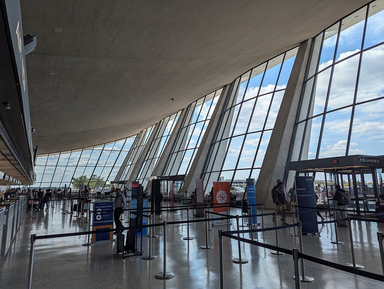 The main terminal at Dulles, its leaning columns and glass wall seen from inside