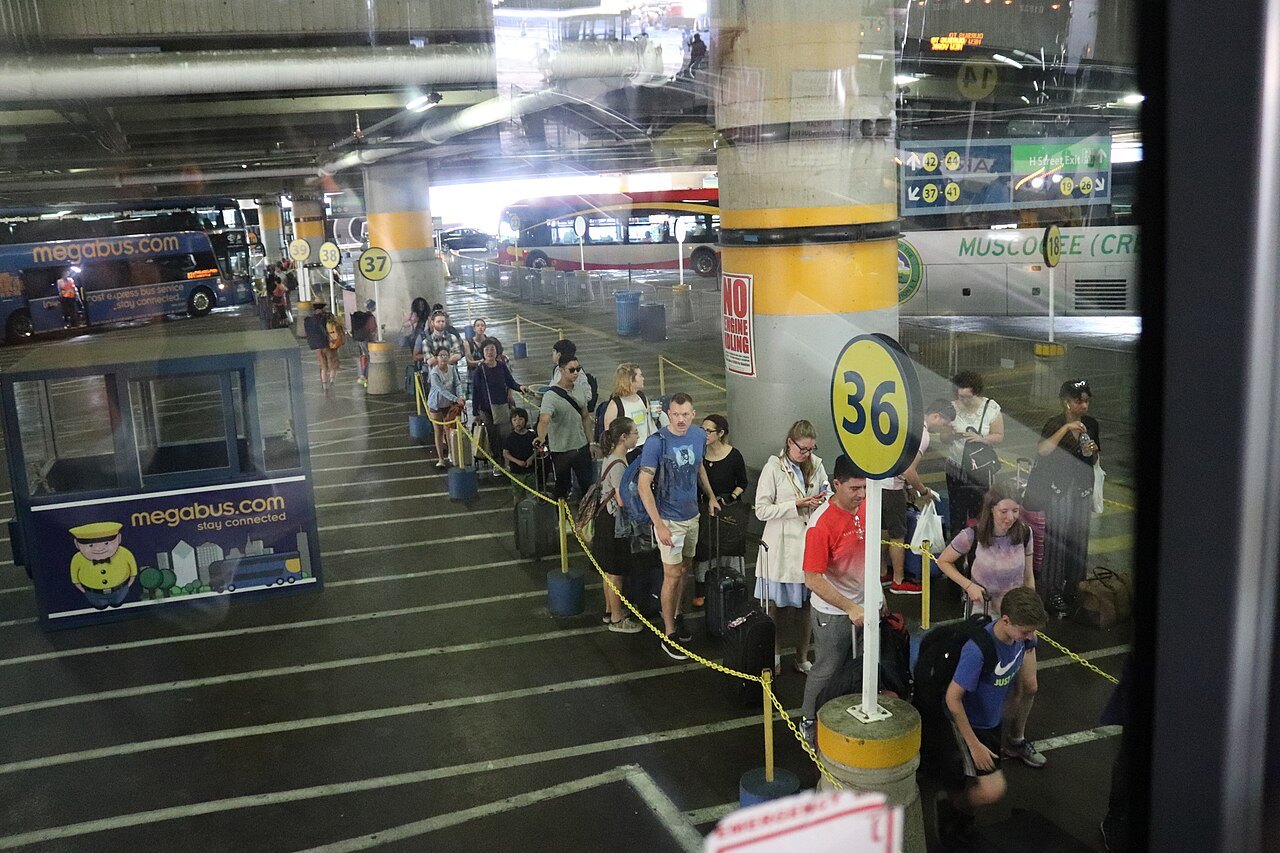 Passengers boarding a double-decker intercity coach at the Union Station bus deck