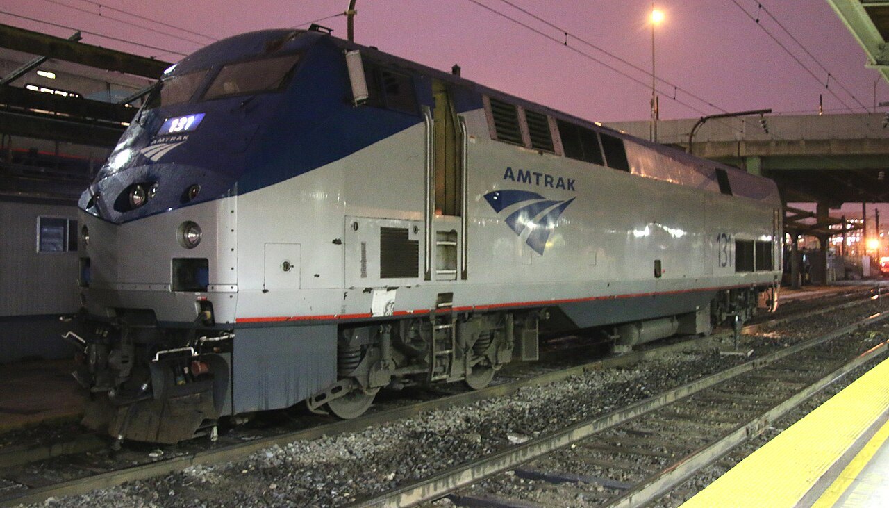 An Amtrak diesel locomotive at dusk in the Union Station yard