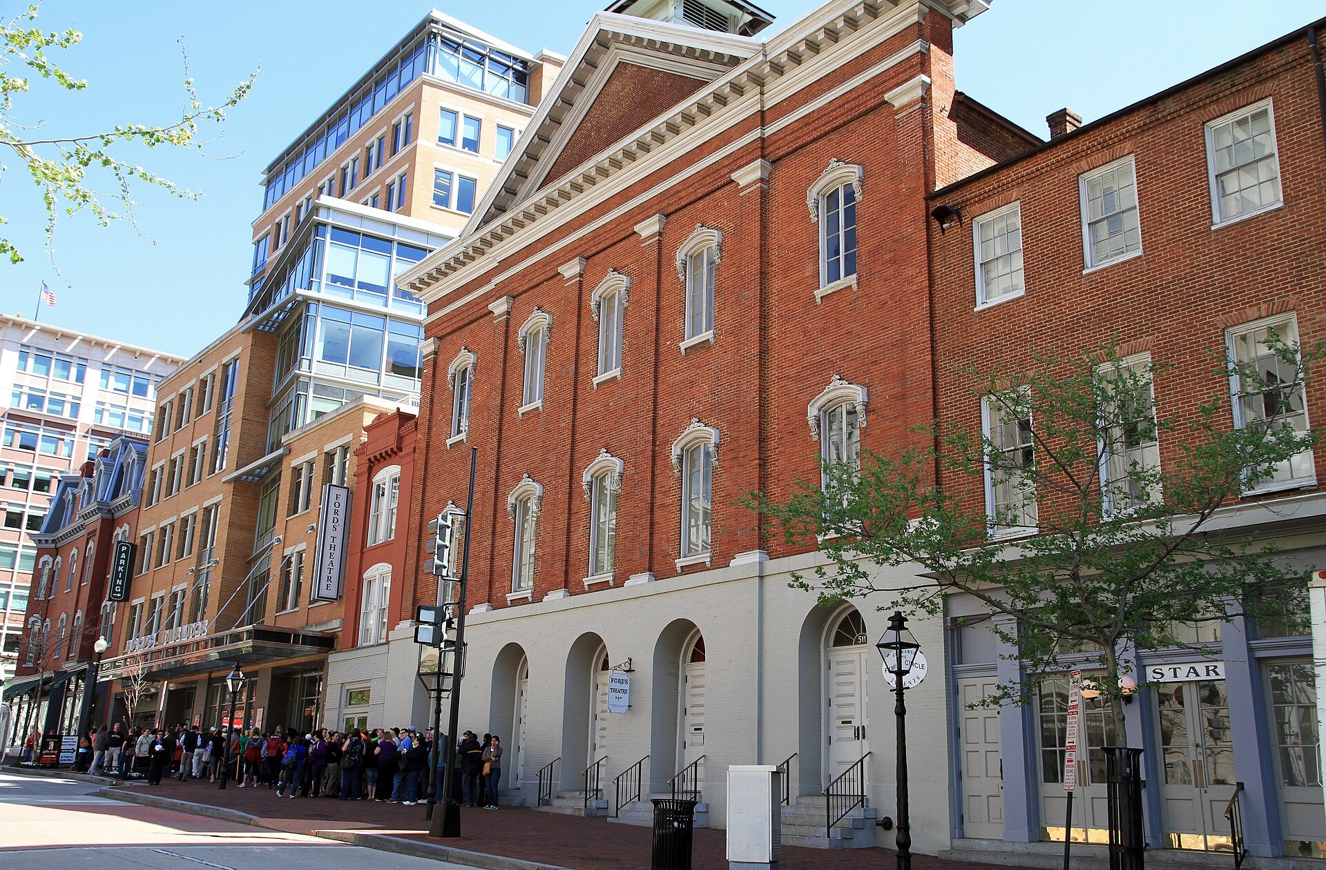 Ford's Theatre's red-brick front on 10th Street, a line of visitors outside