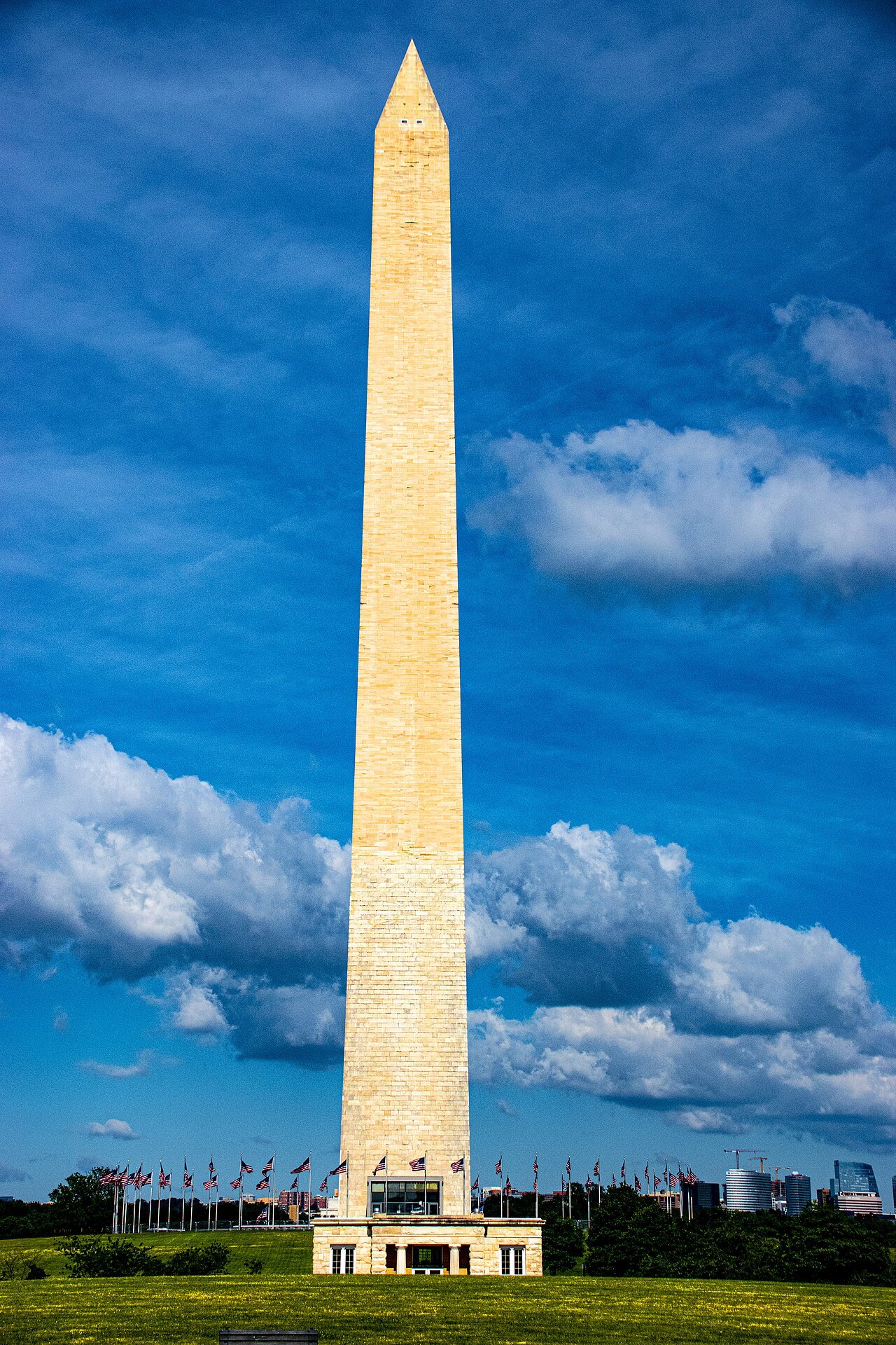 The Washington Monument and its ring of flags on a bright day