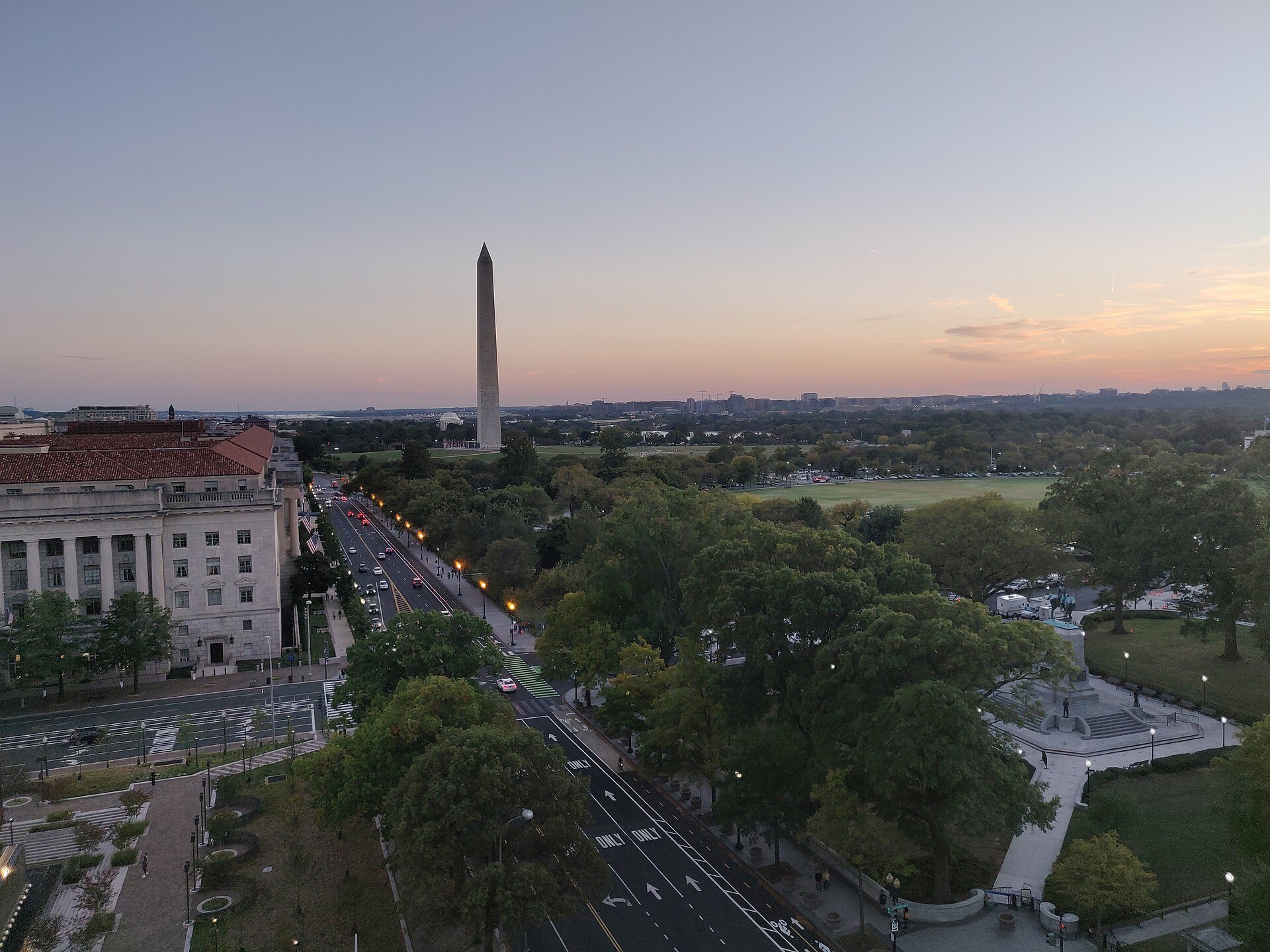 The Washington Monument at dusk above 15th Street and the Ellipse