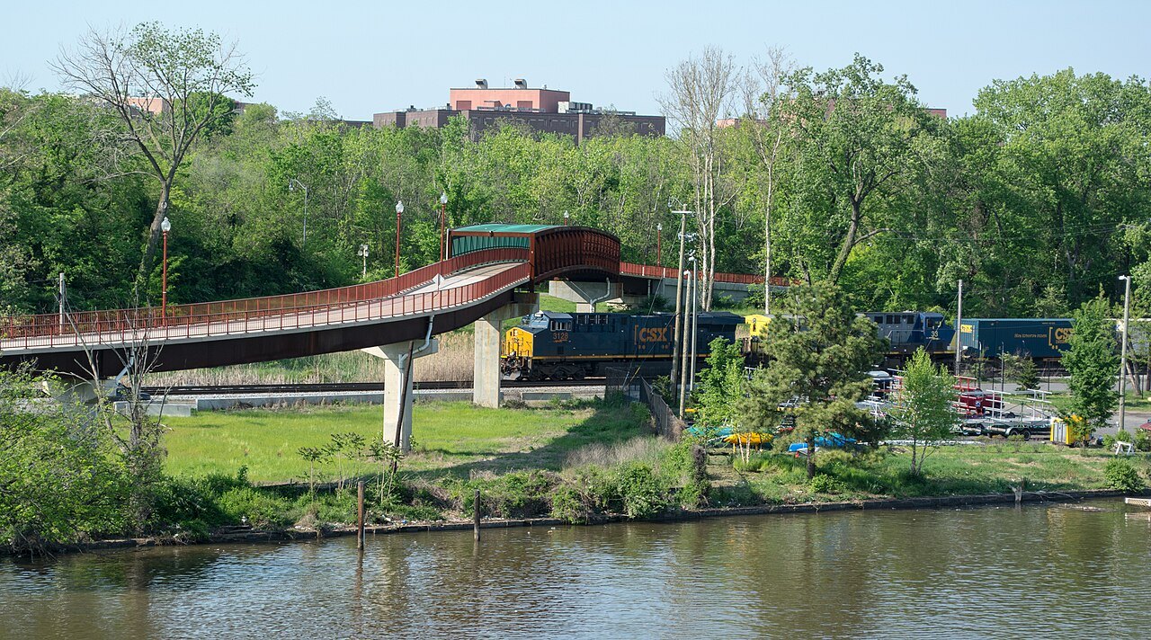 A freight train passing under the Anacostia River Trail bridge