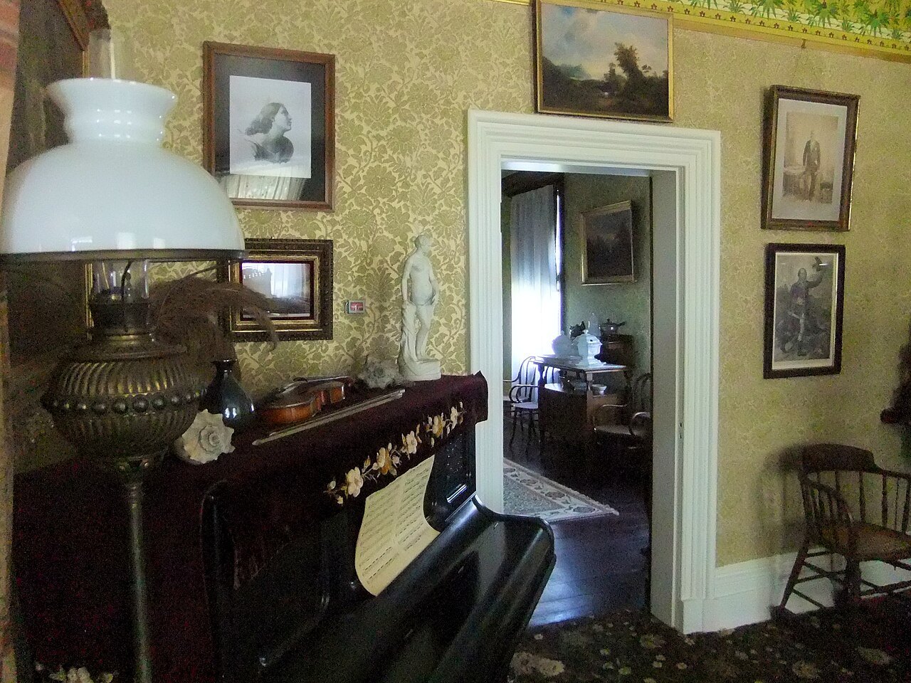 A piano and lamp in the parlor of Cedar Hill