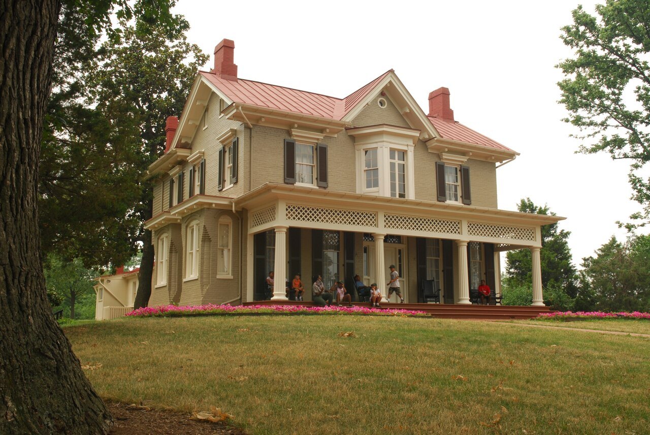 Cedar Hill from the lawn, its porch and bay windows among the trees
