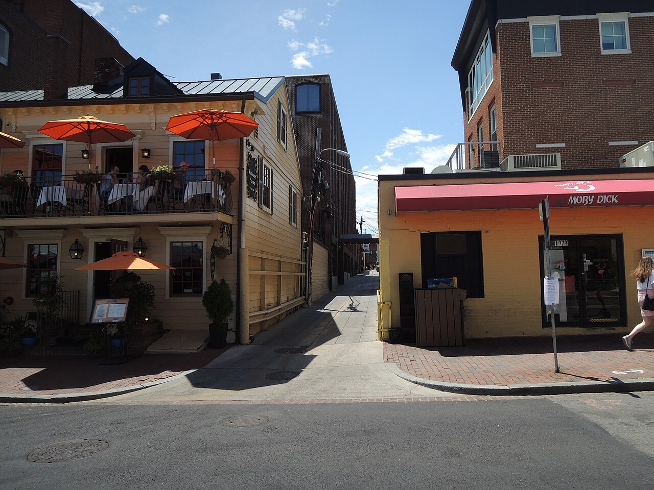 The entrance to Blues Alley from Wisconsin Avenue, restaurant umbrellas above