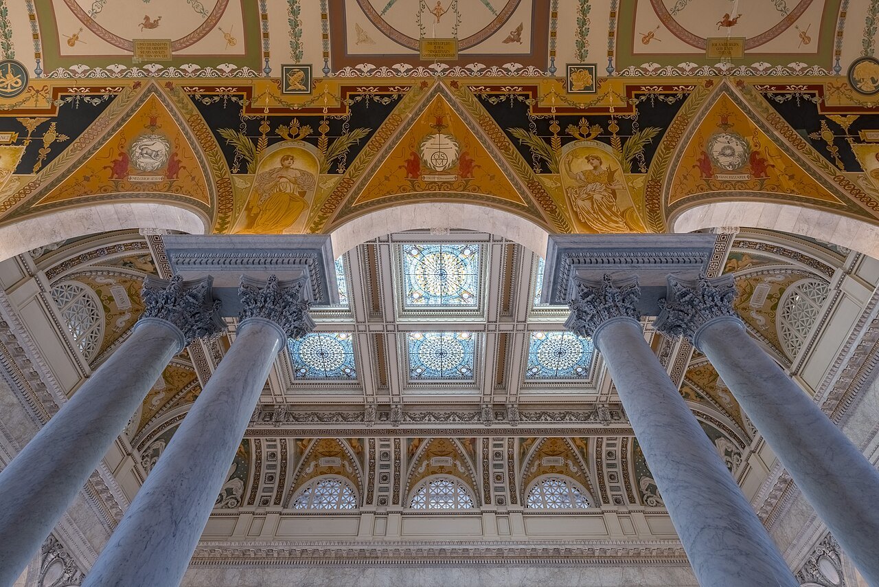 Paired columns rising to the painted and gilded ceiling of the Great Hall
