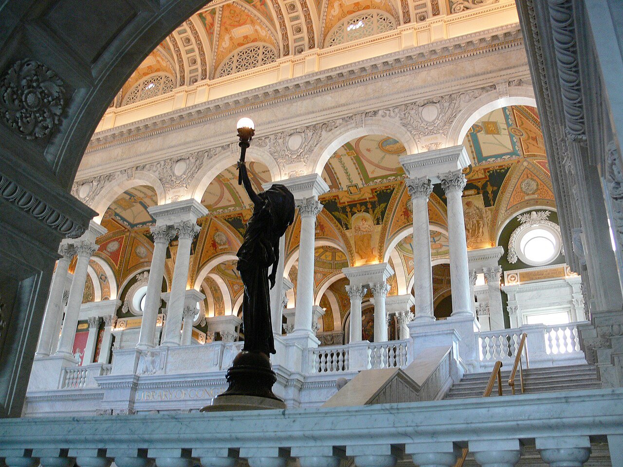 The Great Hall of the Jefferson Building, a bronze torchbearer on the stair