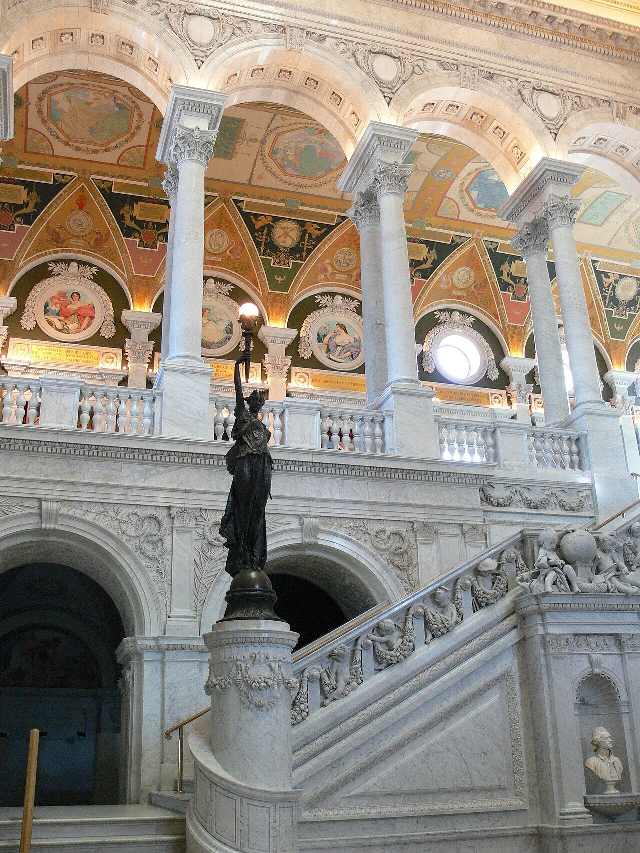 The marble stair and arcades of the Great Hall, lit from above