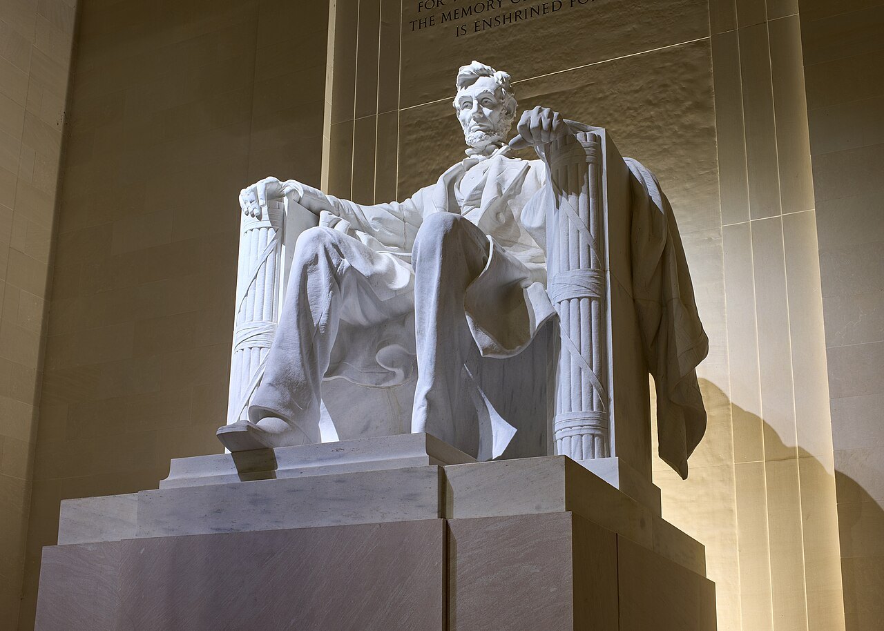 The statue of Lincoln lit from above in the memorial's chamber