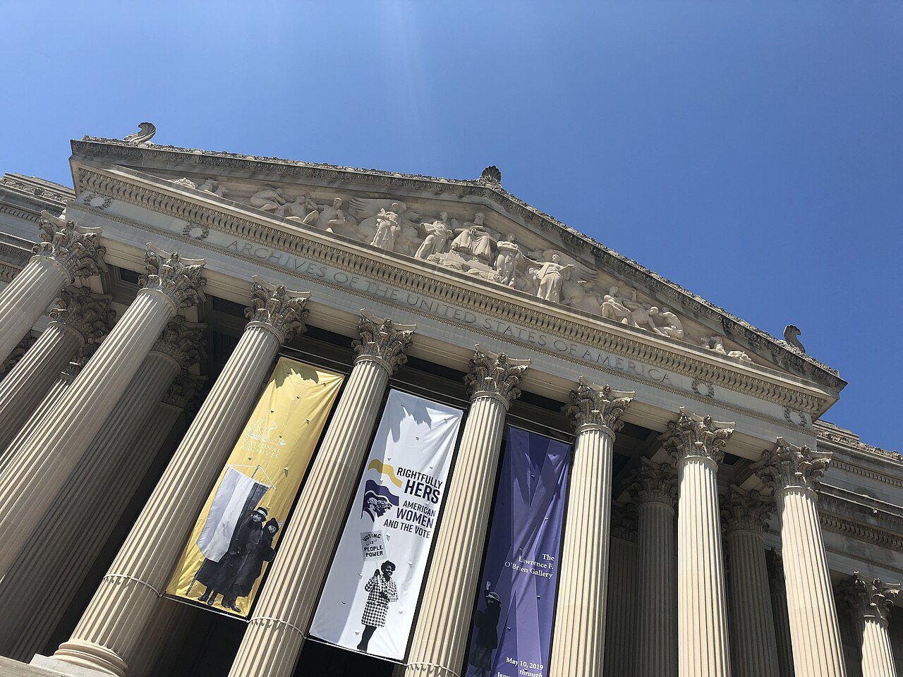 The Archives' Constitution Avenue portico from below, exhibition banners between the columns