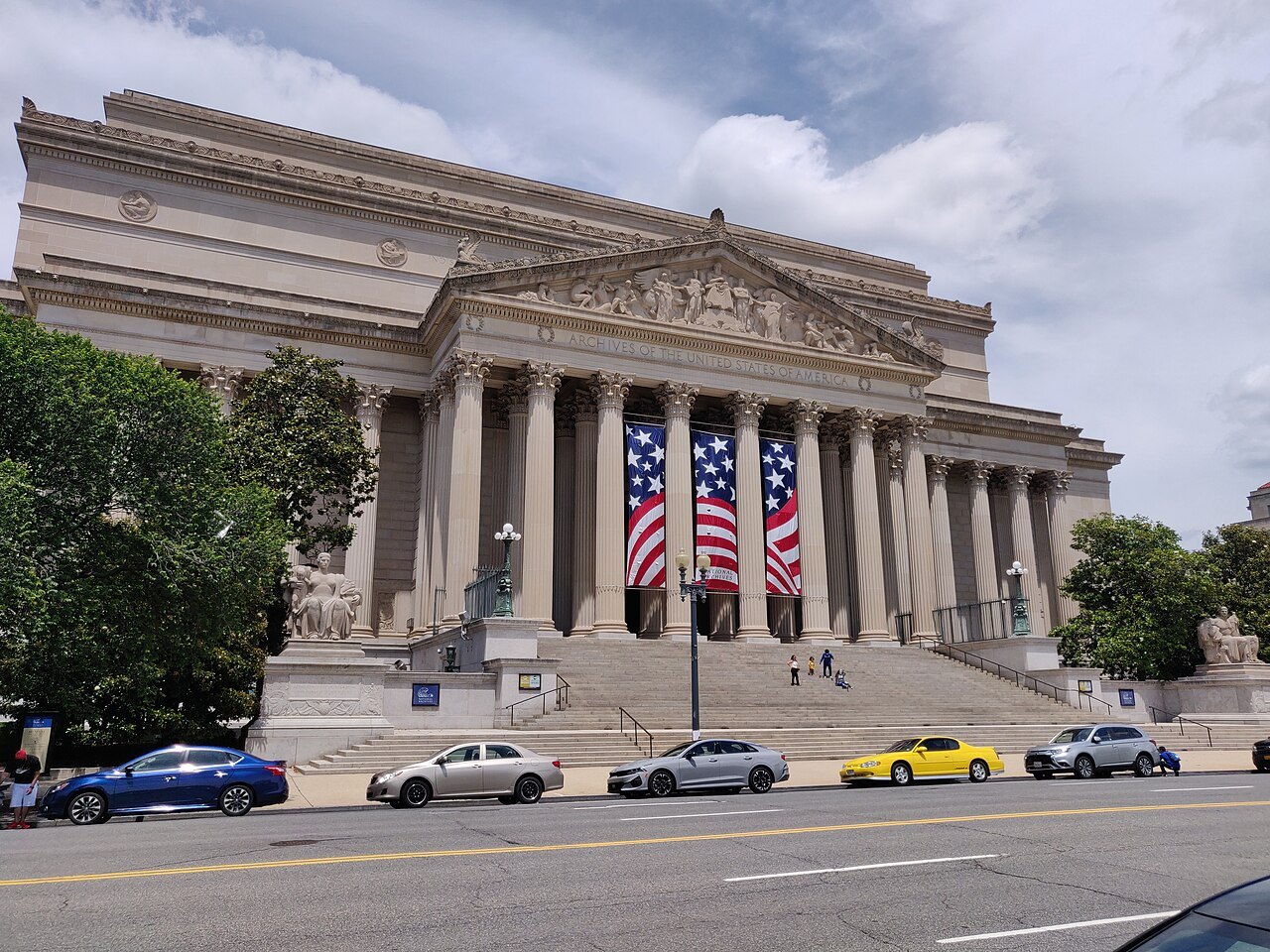 The National Archives from Constitution Avenue, a flag hung in the portico