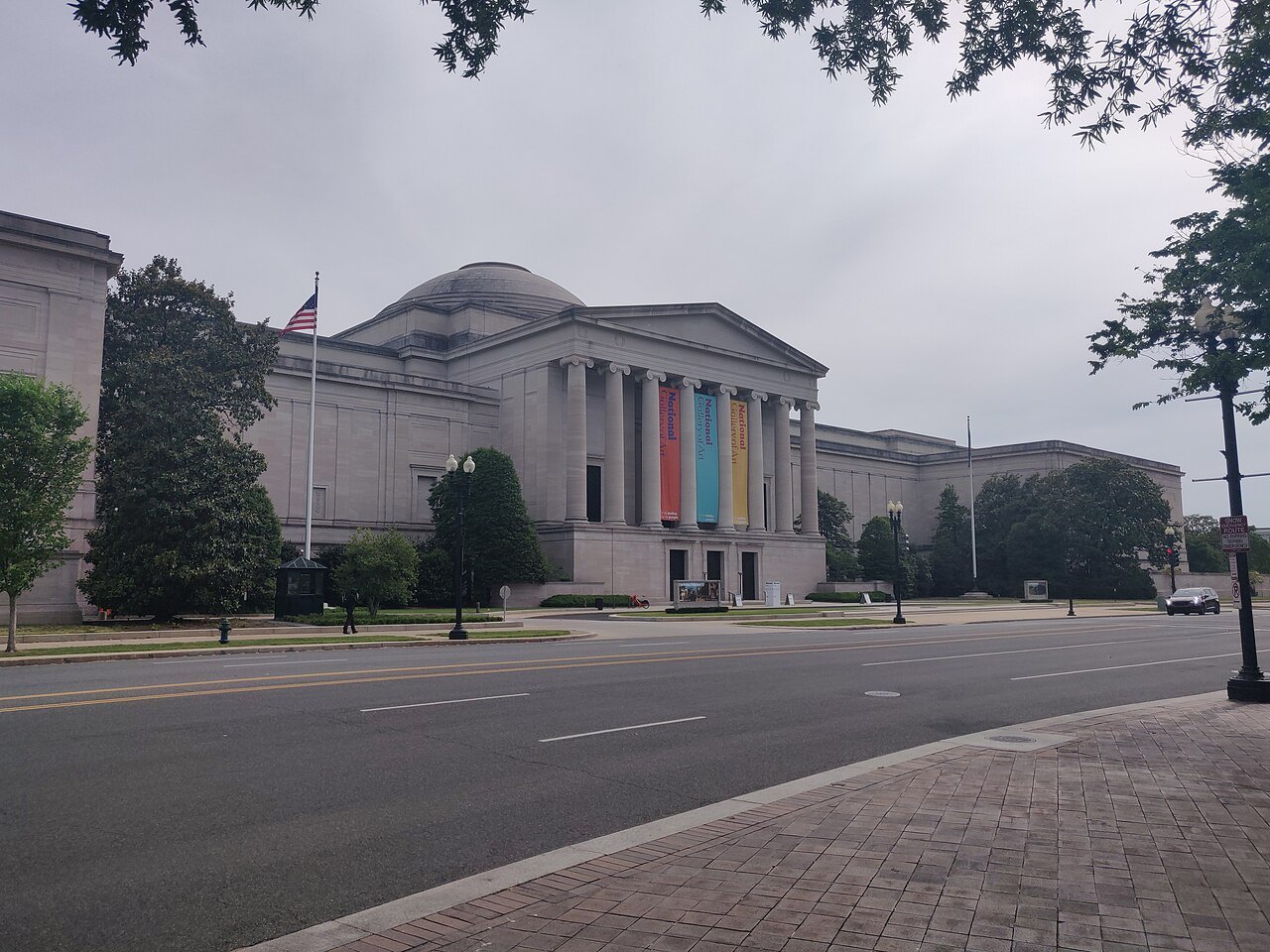 The West Building from Constitution Avenue, banners on its columns