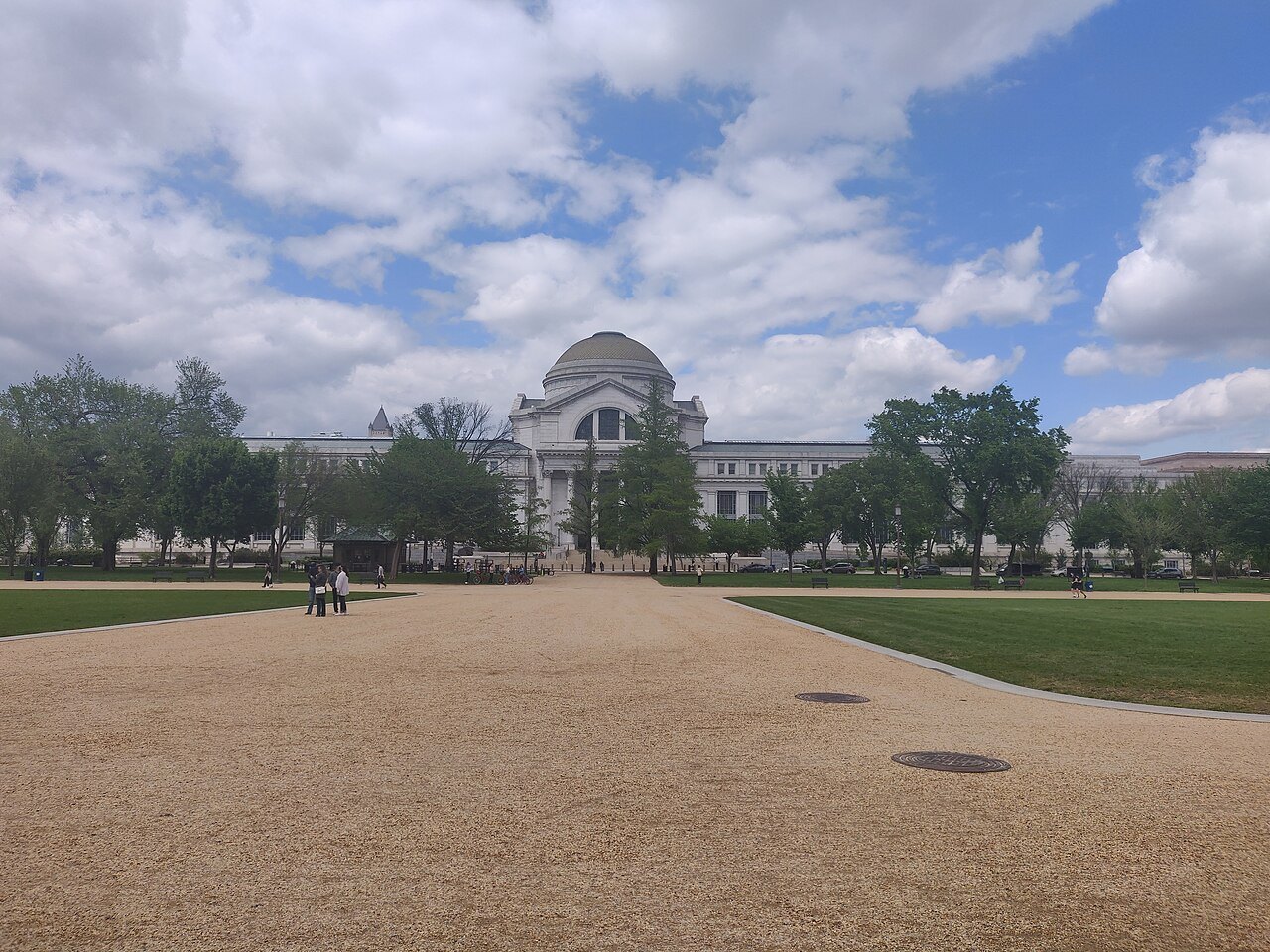The Natural History Museum's dome across the gravel paths of the Mall