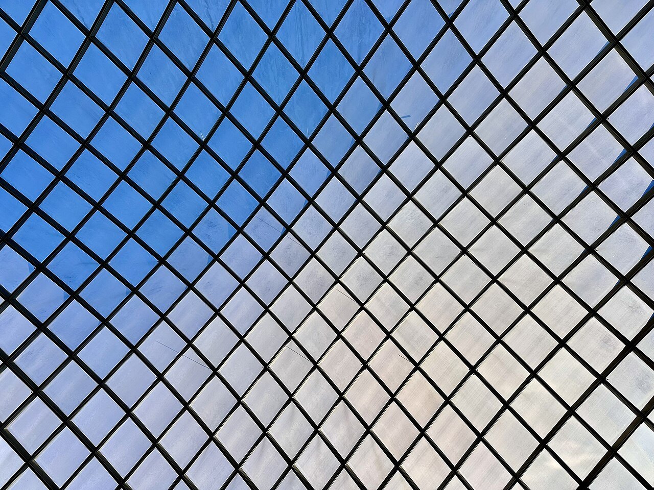 The lattice of the Kogod Courtyard's glass canopy against the sky