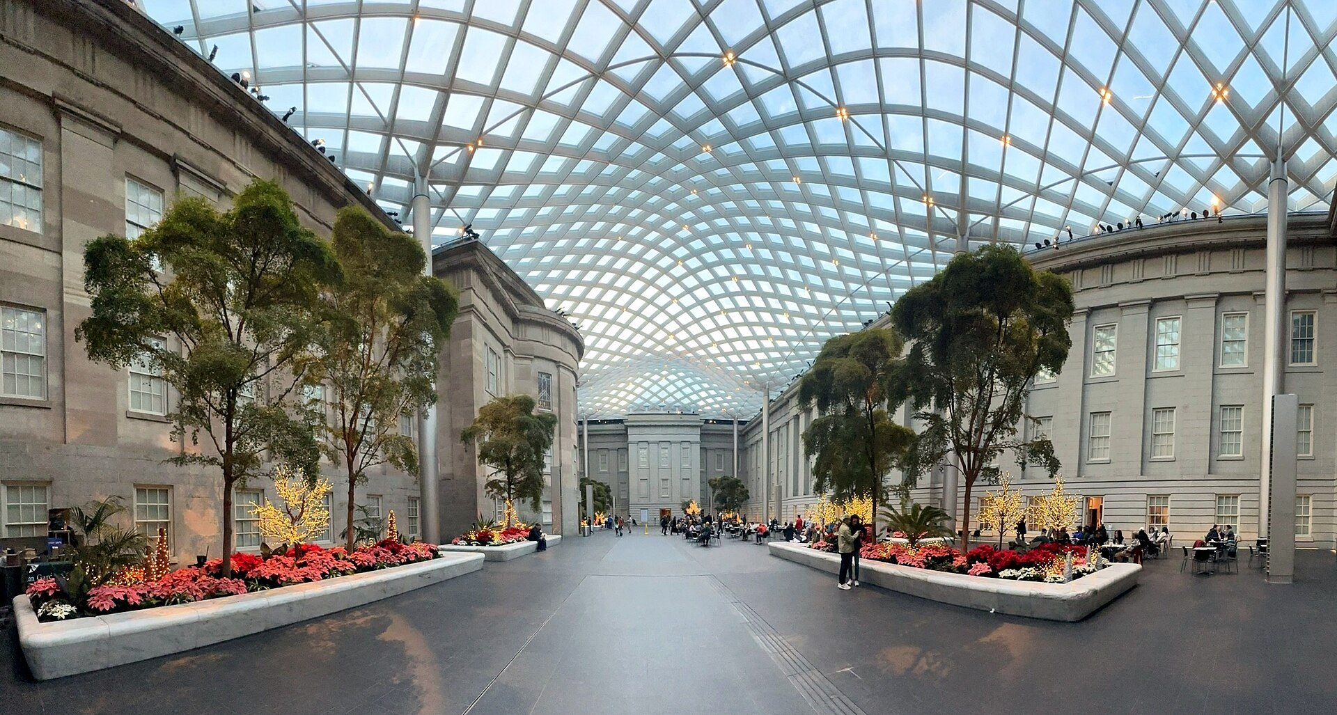 The Kogod Courtyard under its glass canopy, trees in planters