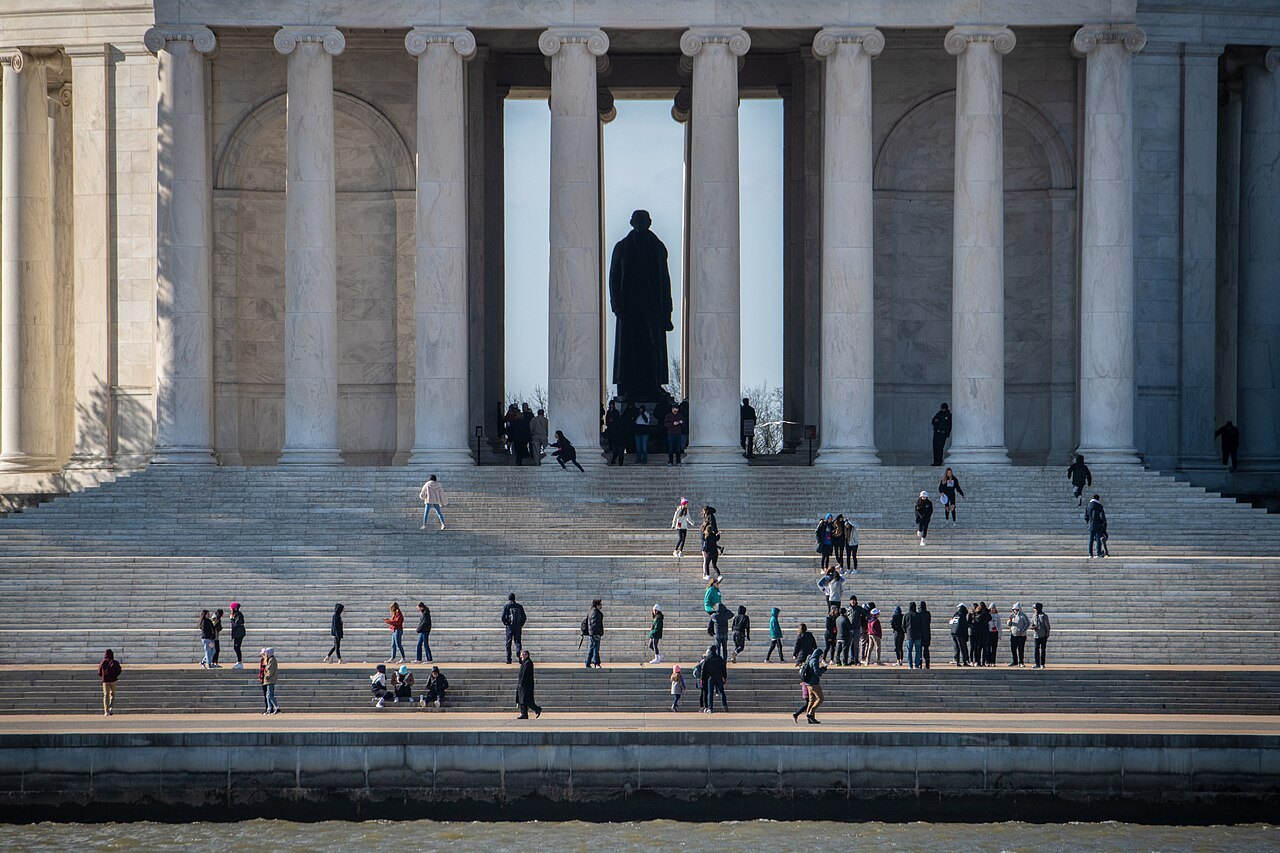 Visitors on the steps of the Jefferson Memorial, the statue between the columns