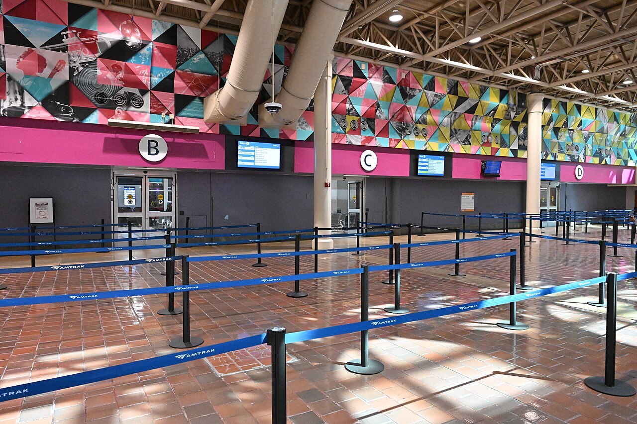 The ticket gates on the concourse at Union Station, under a bright mural