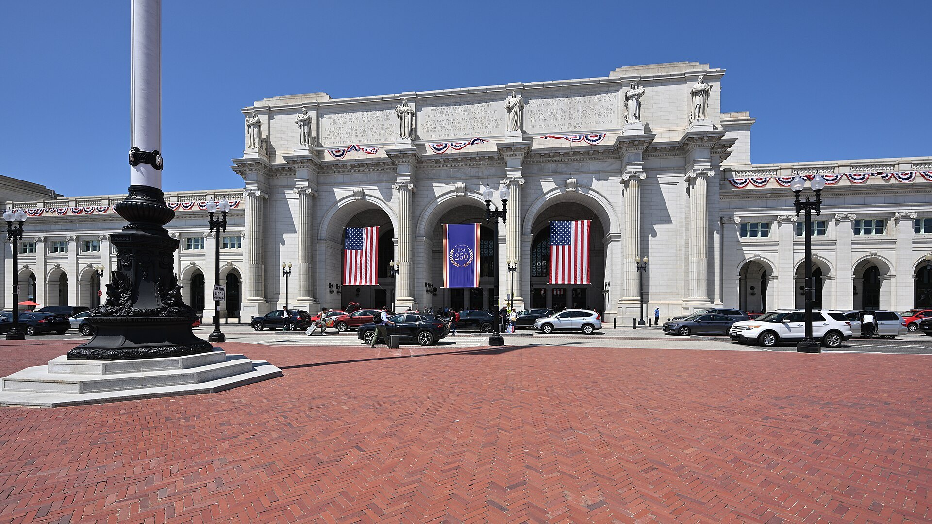 The front of Union Station across Columbus Plaza, flags in its arches