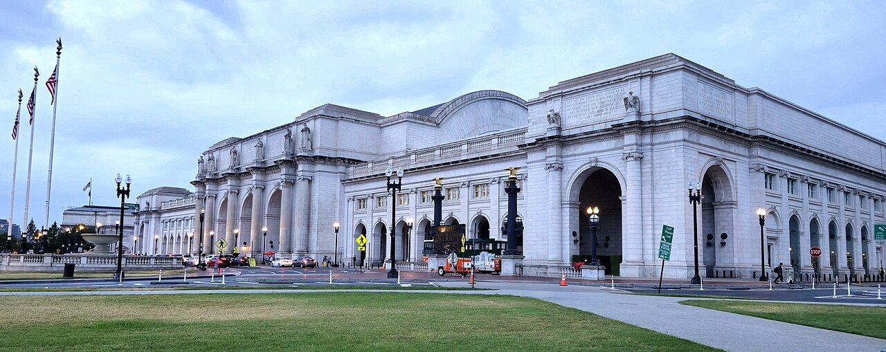 Union Station's white granite front and arches under a blue sky