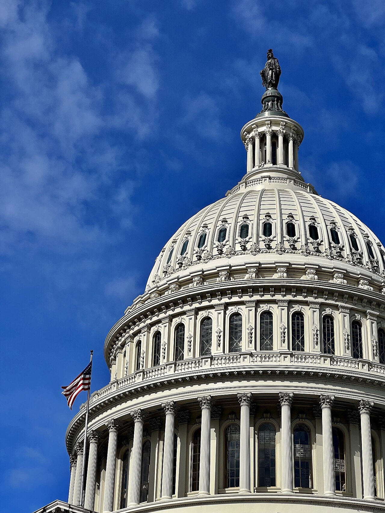 The Capitol dome with the Statue of Freedom on top, against a deep blue sky