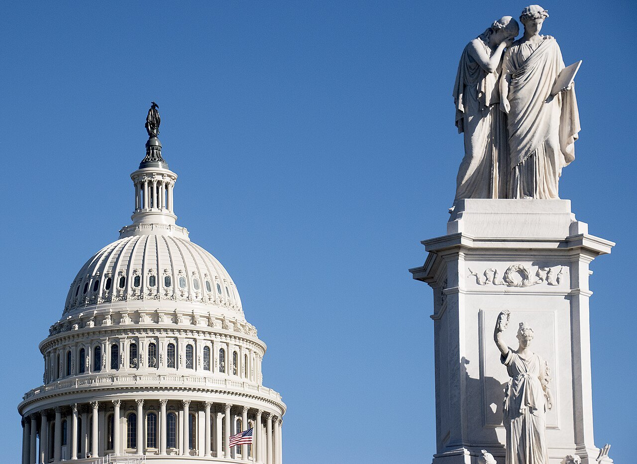 The Peace Monument's marble figures in front of the Capitol dome