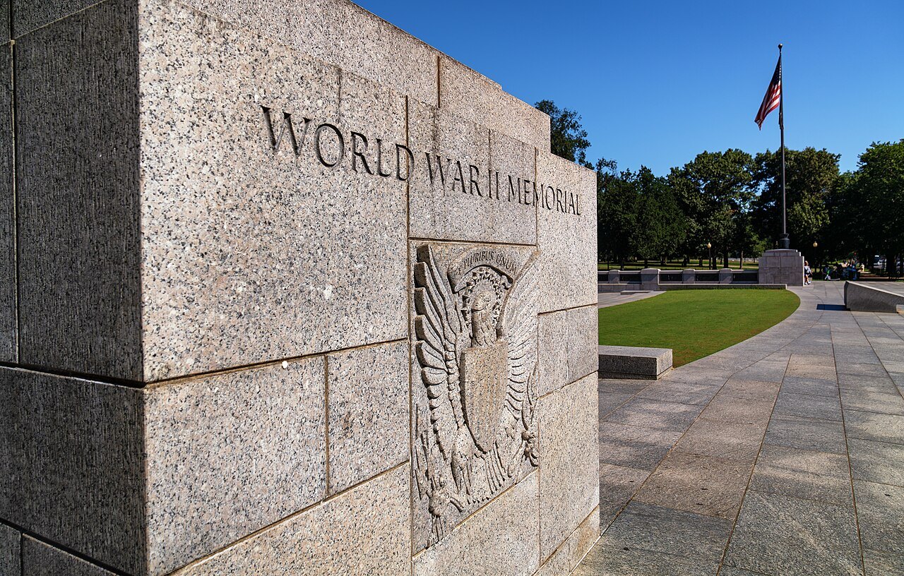 The World War II Memorial's name carved in granite, with its wreath and eagle relief