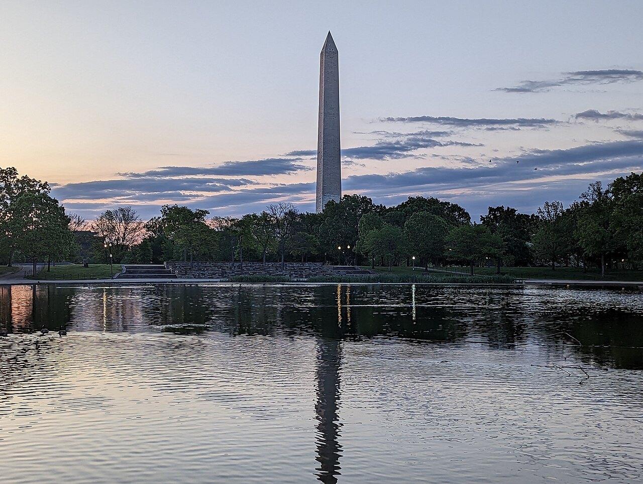 The Monument reflected in Constitution Gardens' pond at dusk