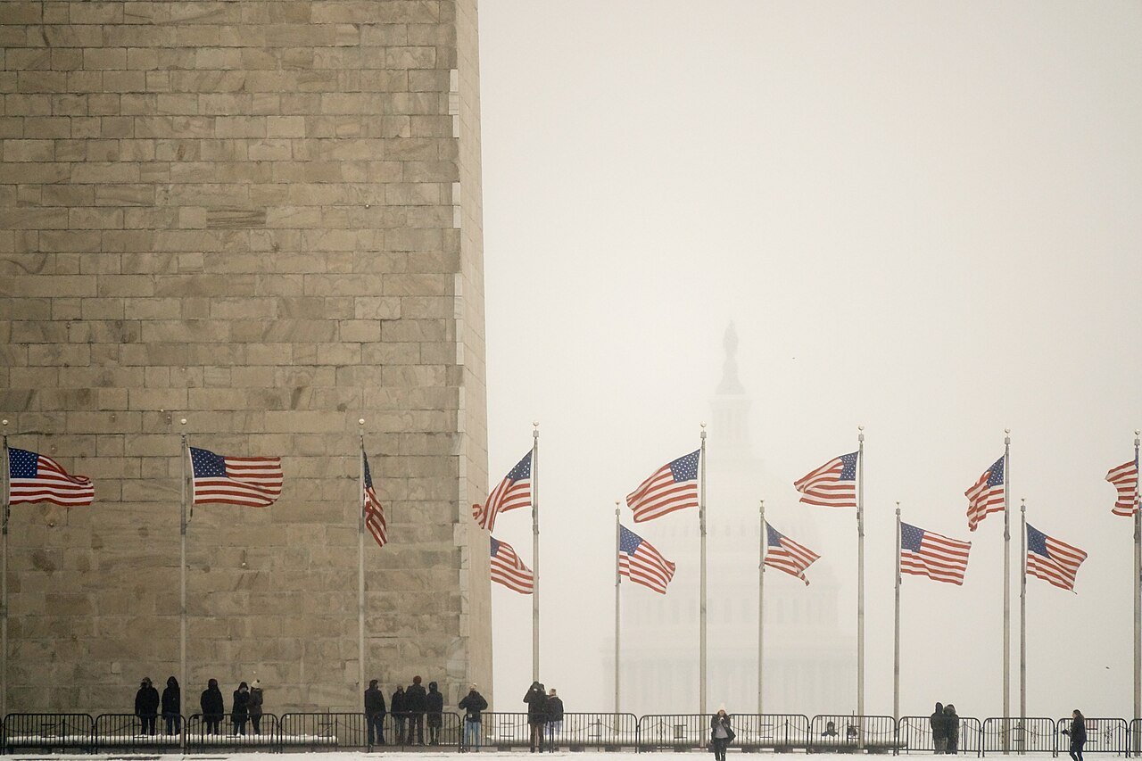 Flags round the base of the Washington Monument in fog