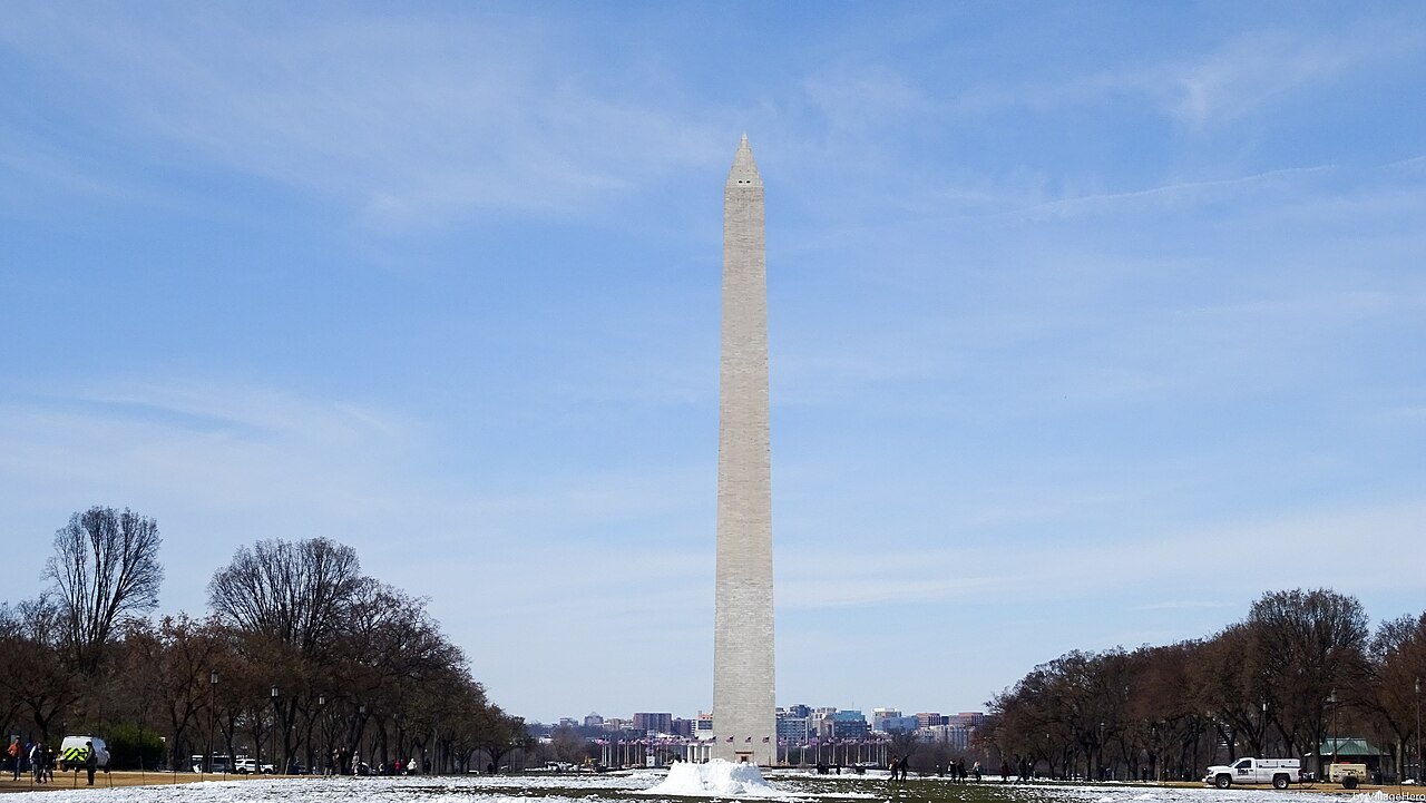 The Washington Monument above the snowy Mall on a clear winter day