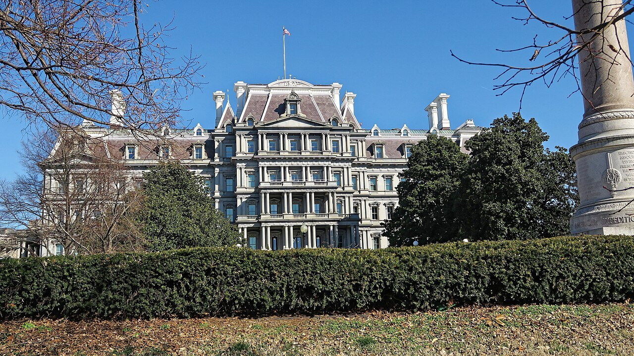 The Eisenhower Executive Office Building beside the White House, seen across its hedge