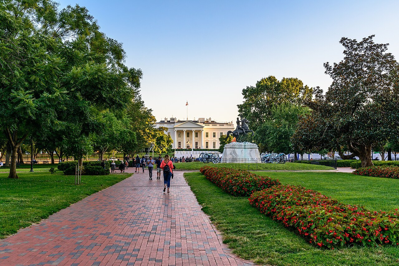 A brick path through Lafayette Square toward the White House, flower beds on either side