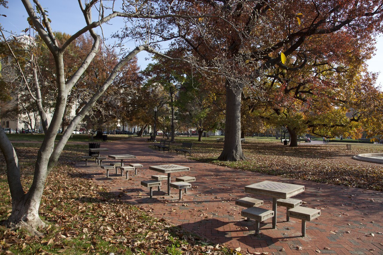 Tables and benches under the trees of Lafayette Square in autumn